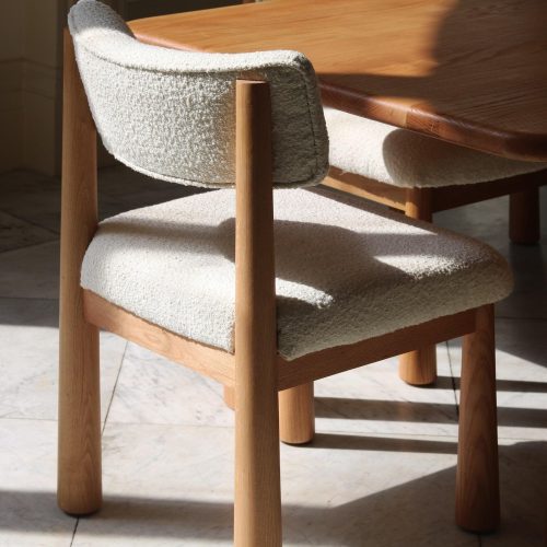 wood upholstered white boucle dining chairs